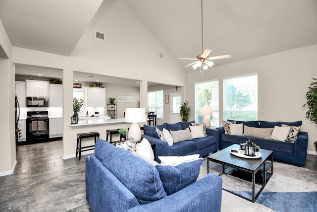 living room featuring ceiling fan and high vaulted ceiling