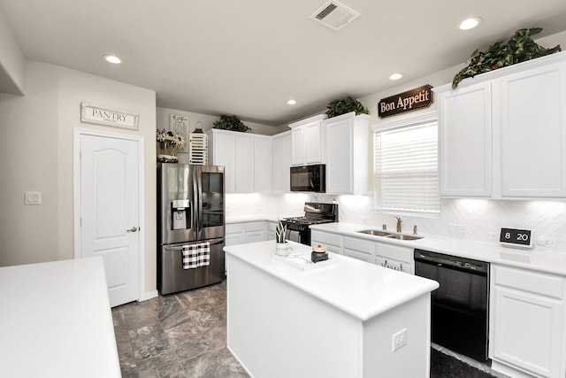 kitchen featuring sink, black appliances, white cabinets, and a kitchen island