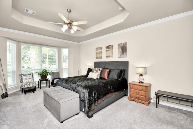 carpeted bedroom with ornamental molding, a raised ceiling, and ceiling fan