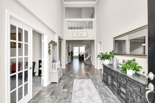 entrance foyer featuring french doors and a high ceiling