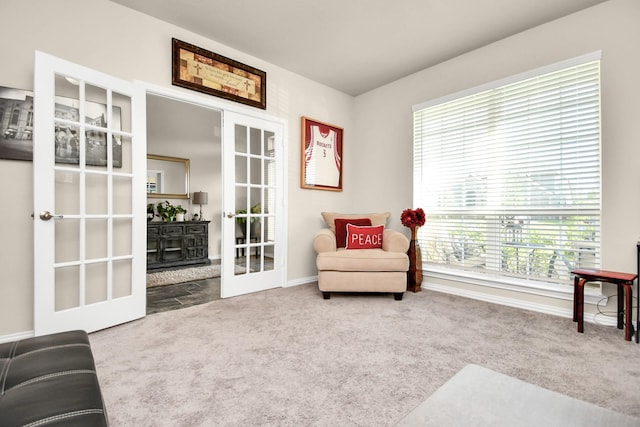 sitting room with french doors and carpet flooring