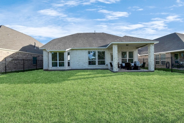 rear view of house featuring a lawn and a patio area