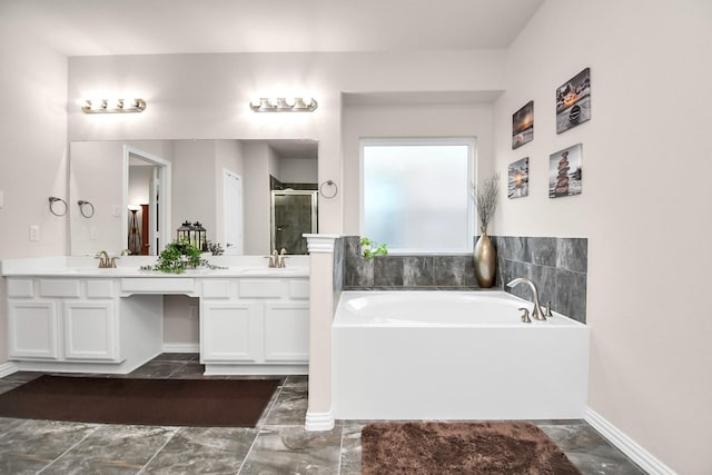 bathroom featuring vanity and independent shower and bath