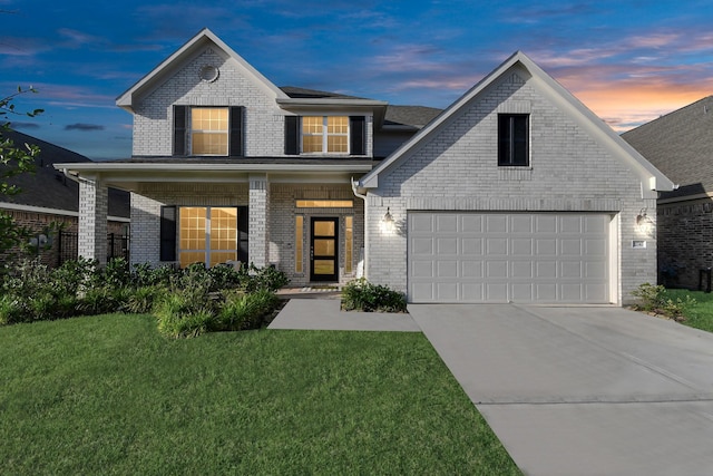 view of front of house with a garage, a lawn, and covered porch