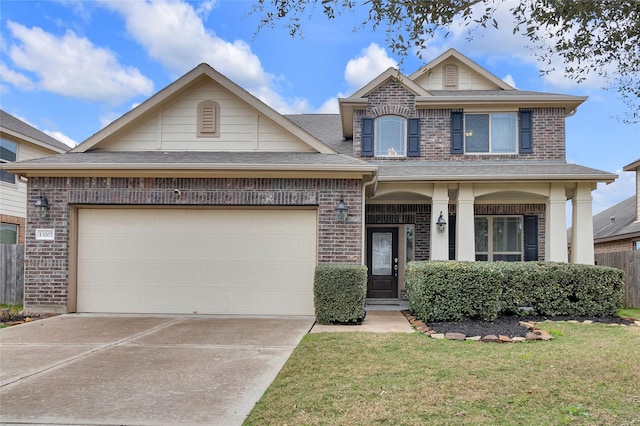 view of front facade featuring a garage and a front lawn