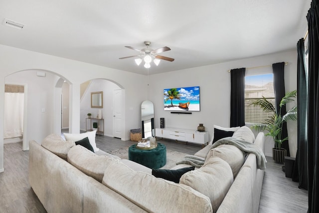 living room with hardwood / wood-style floors and ceiling fan