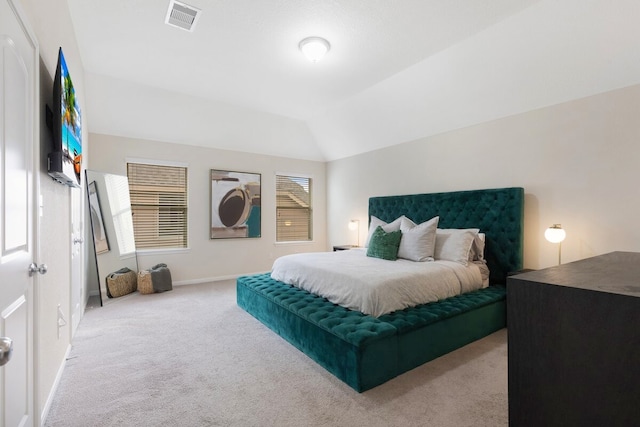 carpeted bedroom with lofted ceiling