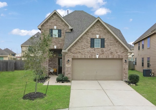 view of front facade with a front yard, a garage, and central AC unit