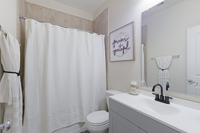 full bathroom with toilet, vanity, and shower / bath combination with curtain