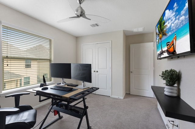 office space with light colored carpet and ceiling fan