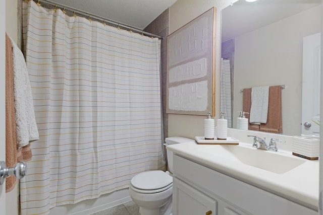 bathroom featuring vanity, tile patterned flooring, and toilet