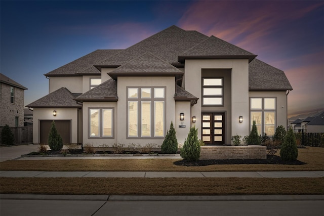 21339 Crescent Winged Dr, Cypress, TX 77433 - view of front facade featuring stucco siding, a garage, driveway, and a shingled roof