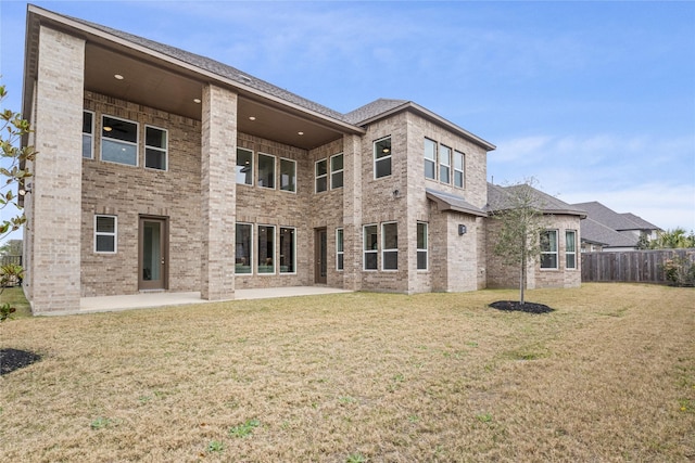 back of property featuring a patio area and a lawn