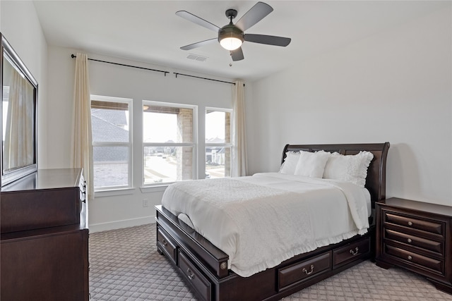 bedroom featuring light colored carpet and ceiling fan