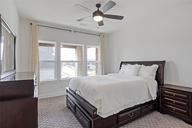 bedroom featuring baseboards, ceiling fan, light colored carpet, and visible vents