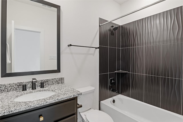 full bathroom with tiled shower / bath combo, vanity, and toilet