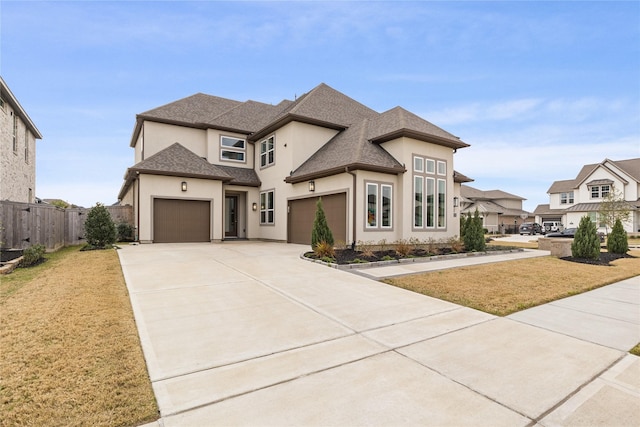 french country inspired facade featuring stucco siding, a front lawn, fence, and driveway