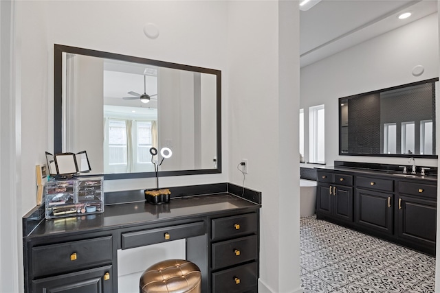 bathroom featuring a freestanding bath, vanity, ceiling fan, and tile patterned floors