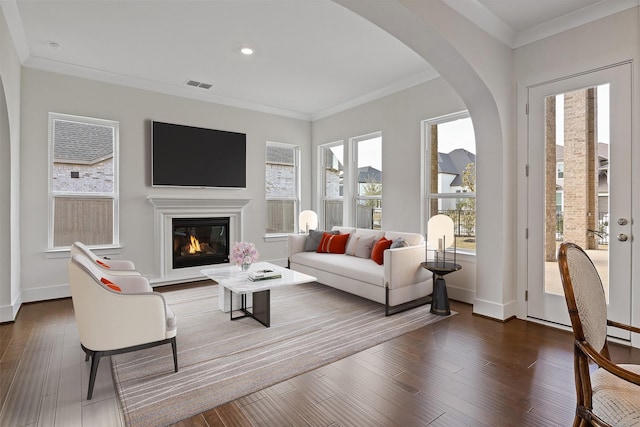 living room featuring dark wood-type flooring and ornamental molding