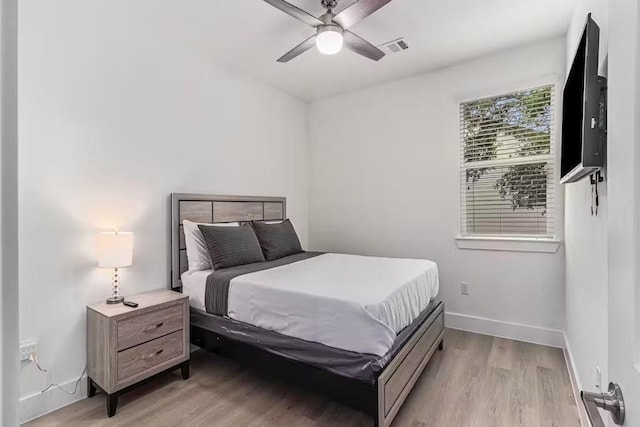 bedroom with ceiling fan and light hardwood / wood-style floors