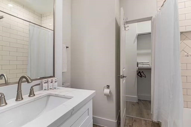 bathroom with vanity, hardwood / wood-style flooring, and walk in shower