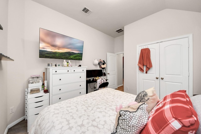 bedroom featuring lofted ceiling, hardwood / wood-style floors, and a closet