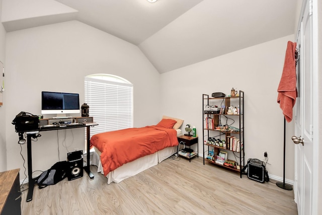 bedroom featuring vaulted ceiling and light hardwood / wood-style floors