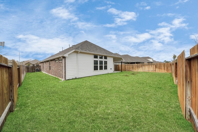 rear view of house with a yard