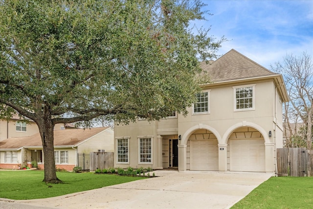 view of front of property with a garage and a front yard