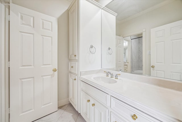 bathroom featuring tile patterned flooring, vanity, and crown molding