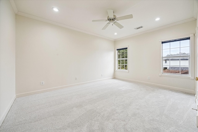 spare room featuring crown molding, light carpet, and ceiling fan