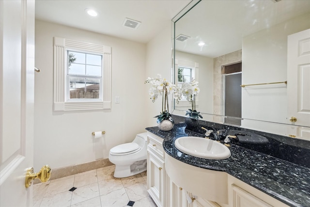 bathroom featuring an enclosed shower, vanity, and toilet