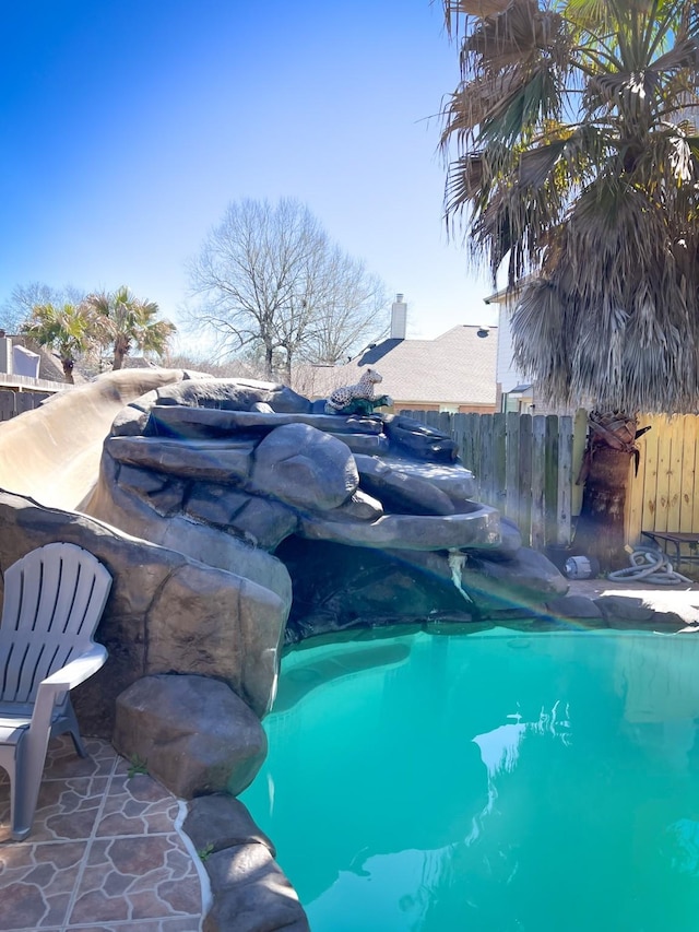 view of swimming pool with fence and a fenced in pool