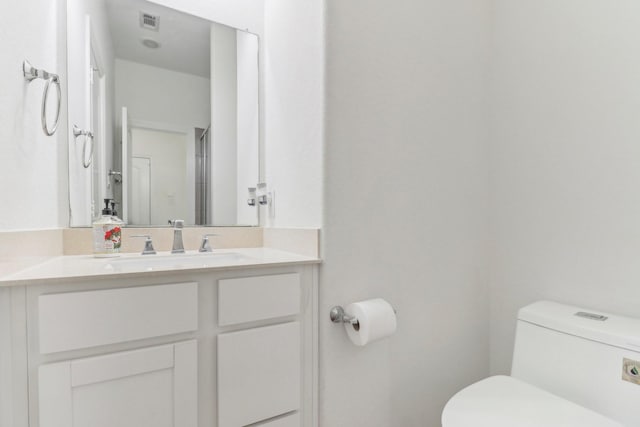 bathroom featuring vanity and toilet