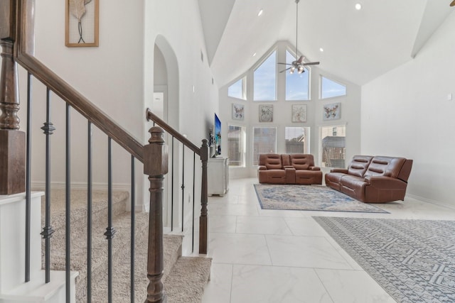 living room featuring high vaulted ceiling and ceiling fan