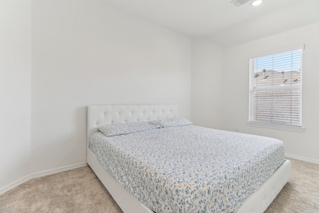 carpeted bedroom with lofted ceiling