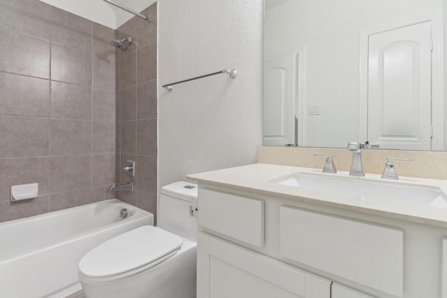 full bathroom with tiled shower / bath combo, vanity, and toilet