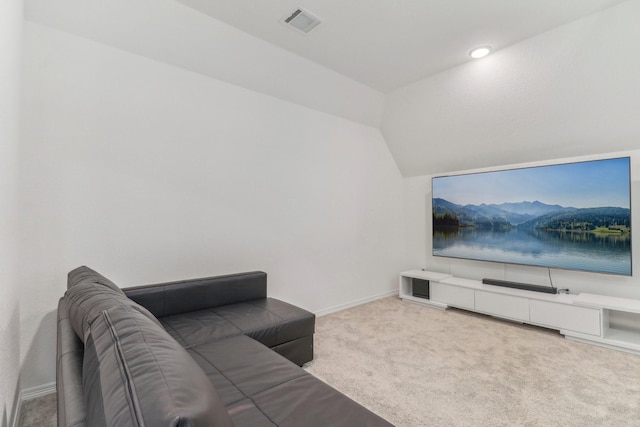 carpeted living room featuring vaulted ceiling