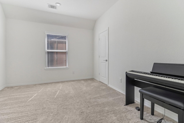 sitting room featuring vaulted ceiling and light colored carpet