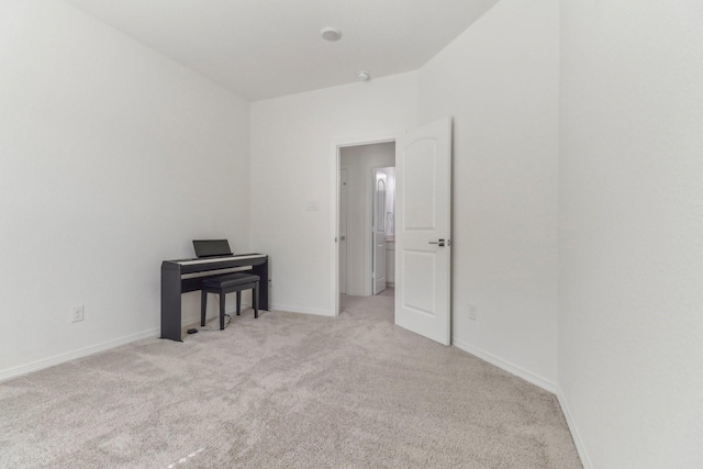 spare room featuring light colored carpet