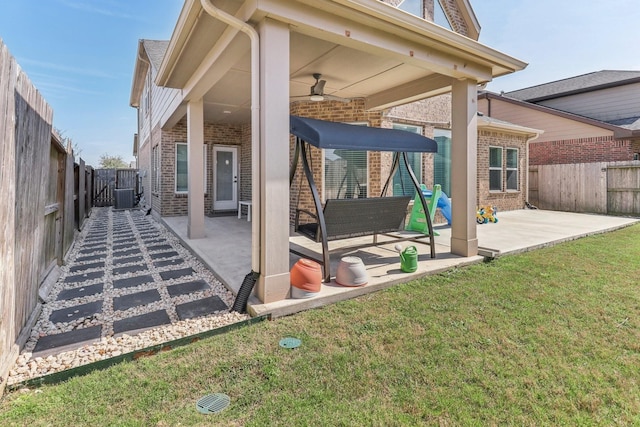 rear view of house with a patio, a lawn, ceiling fan, and cooling unit