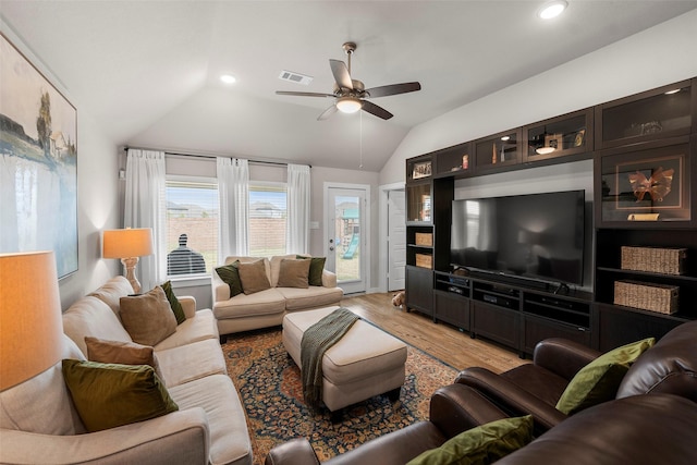 living room featuring light hardwood / wood-style flooring, vaulted ceiling, and ceiling fan