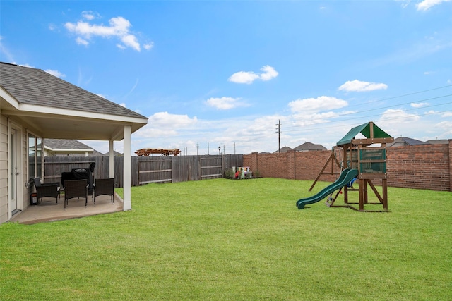 view of yard with a playground and a patio