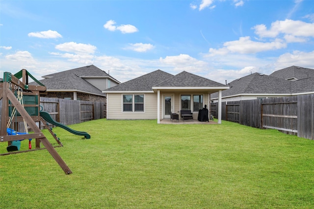 back of house with a playground, a patio, and a yard