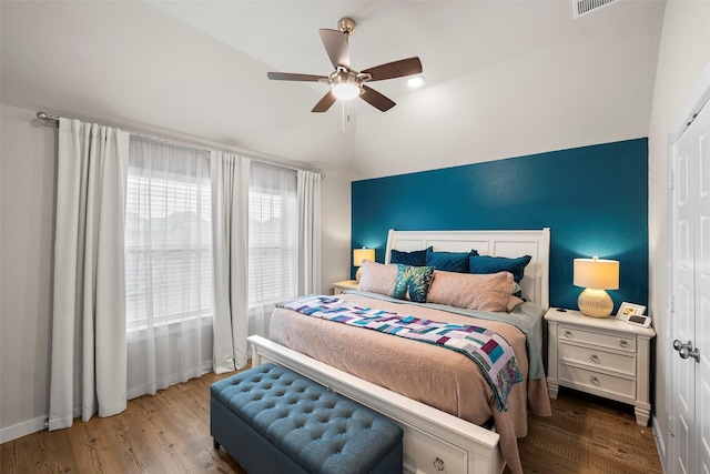 bedroom with hardwood / wood-style flooring, vaulted ceiling, and ceiling fan