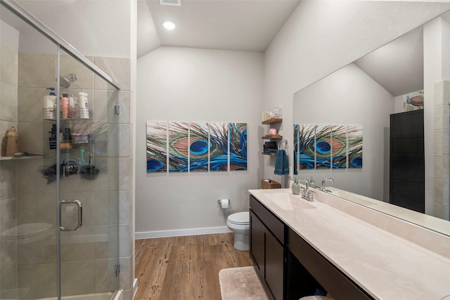 bathroom featuring lofted ceiling, an enclosed shower, vanity, wood-type flooring, and toilet