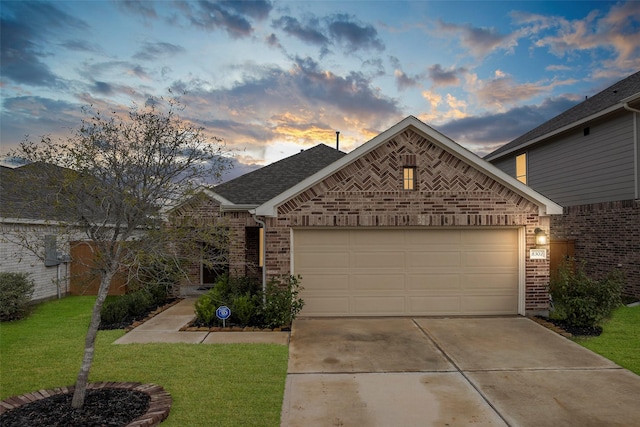 view of front facade with a garage and a yard