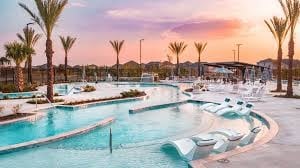 pool at dusk featuring a patio