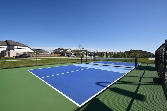 view of tennis court featuring basketball hoop