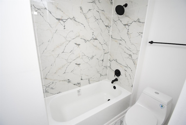 bathroom featuring toilet and tiled shower / bath combo